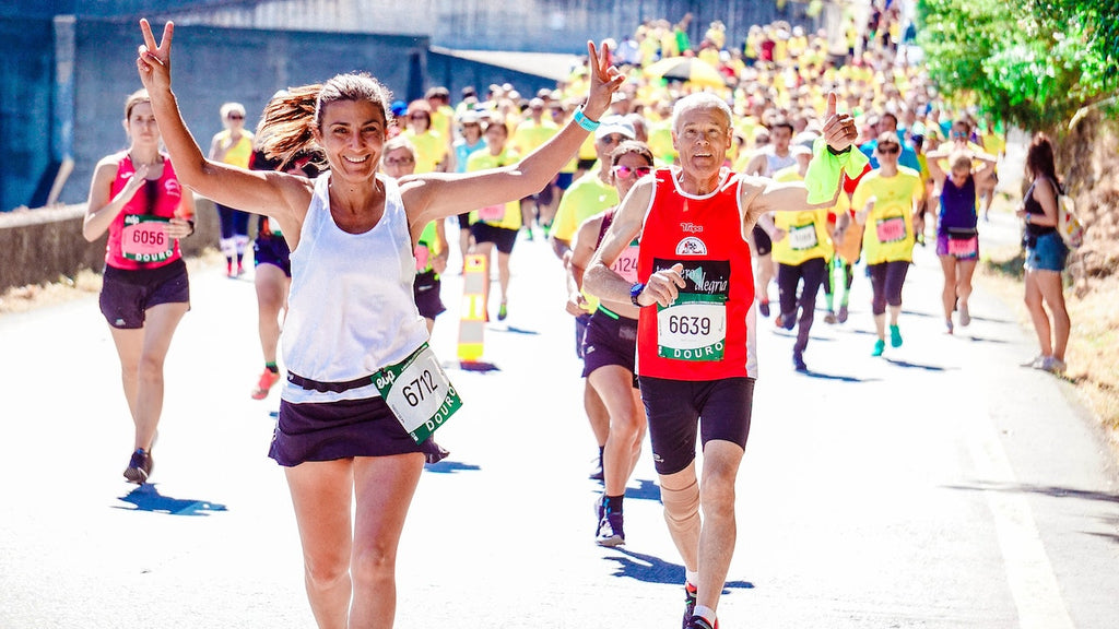 An older man and woman compete in a marathon.