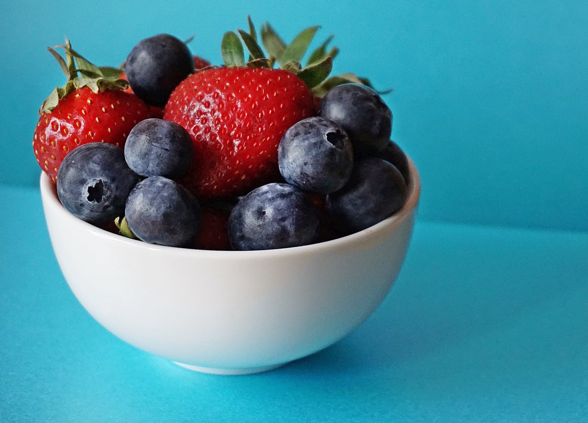 Strawberries and blueberries in a bowl.