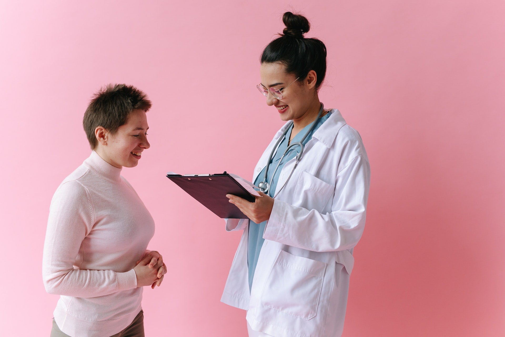 A doctor reviews a chart with a patient.