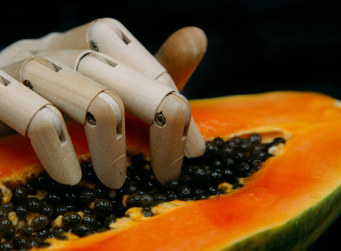 Model hand placed on papaya - guava fruit