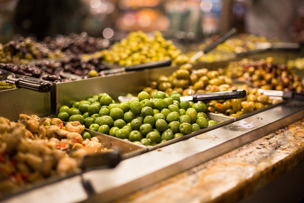 Different varieties of olives for sale at a market stall