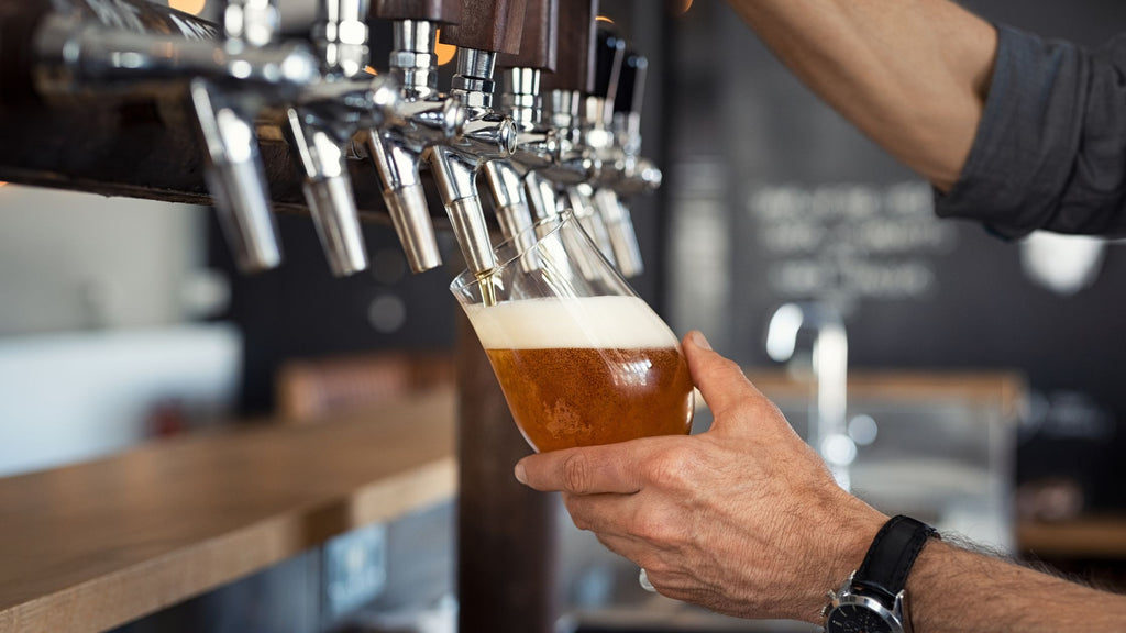 Bar tender pouring a draught beer