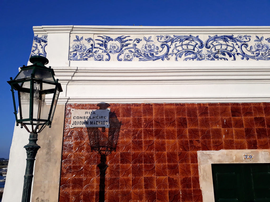 Bright glazed Portuguese tiles on a house in the Algarve