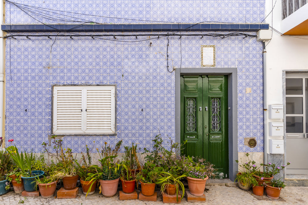 Blue and white Tile clad facade of a simple town house in the Algarve in Portugal