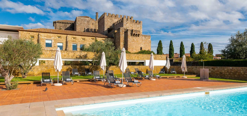 View of pool and monastery at Pousada do Crato in the Alentejo region in Portugal