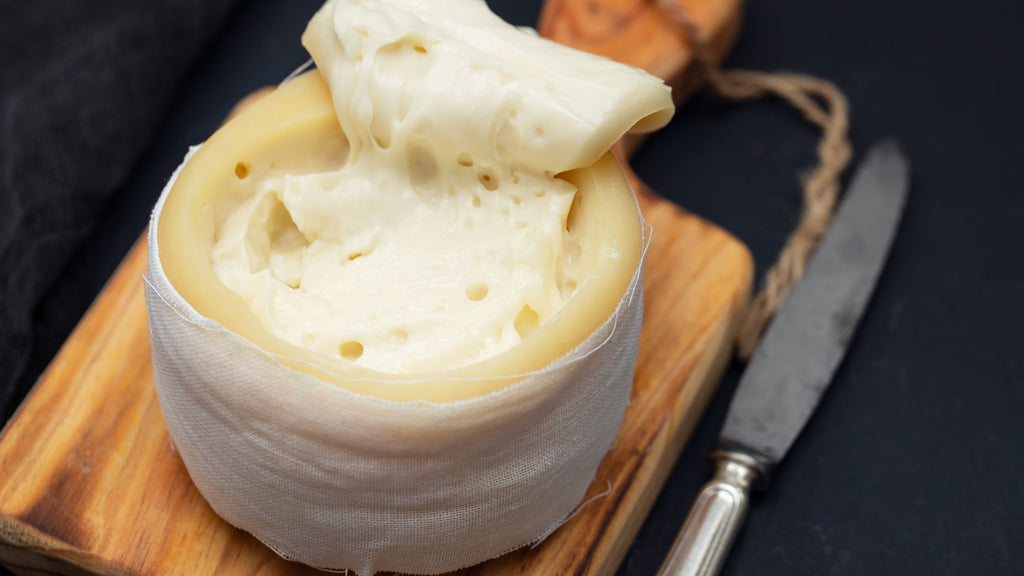 Serra cheese from northern Portugal cut open on a wooden board