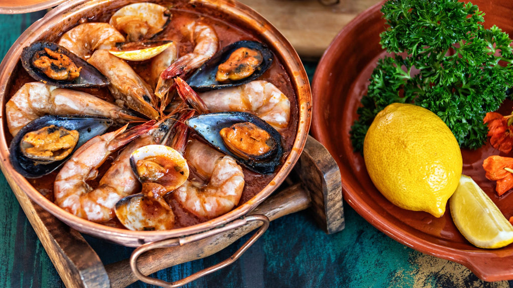 Portuguese seafood cataplana in copper pot