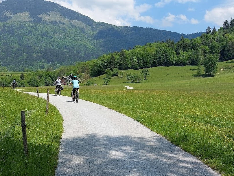 Three cyclists on a graded gravel road on a bike tour in Slovenia