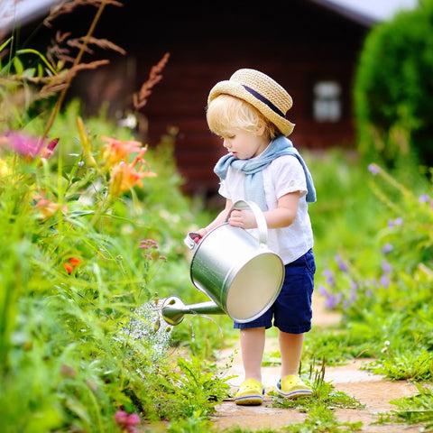 Child Watering Garden with Watering Can