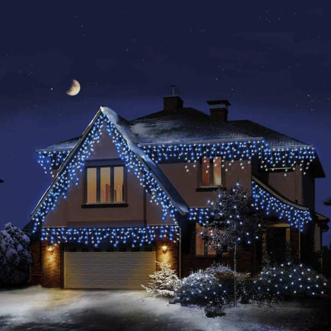 House at Night with Christmas Icicle Lights hanging from gutters