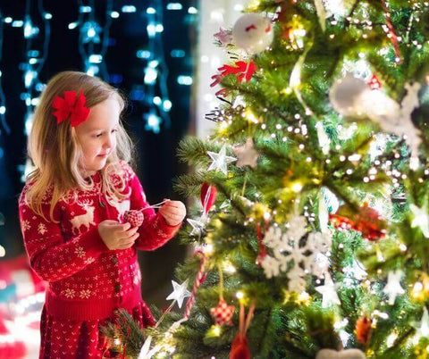 Little Girl Decorating Christmas Tree