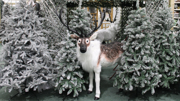 Reindeer in Alpine Ski Lodge Display with Snow Tipped Artificial Christmas Trees