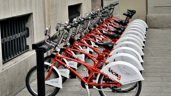 A row of red bicycles for public hire, to take a tour around the streets of Barcelona