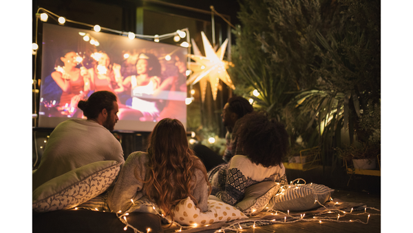 People watching movie outdoor with NOMVDIC projector