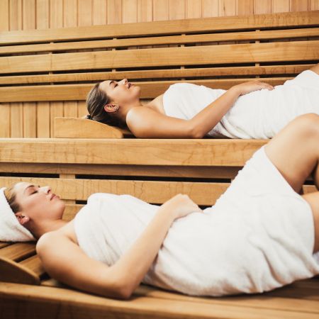 Women lying down in sauna in Canada
