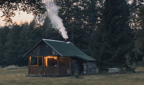 Chimney with smoke rising out of cabin