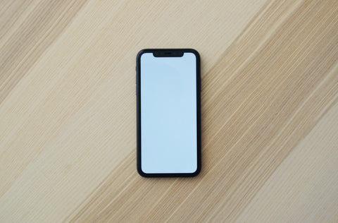 iPhone flat on wooden table