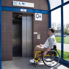 Man using a lift for disabled access in a wheelchair.