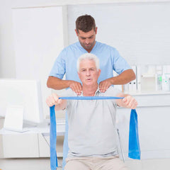 Elderly man receiving physiotherapy.