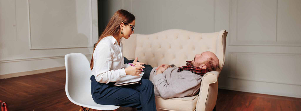 Counselling elderly man while laying on the lounge.