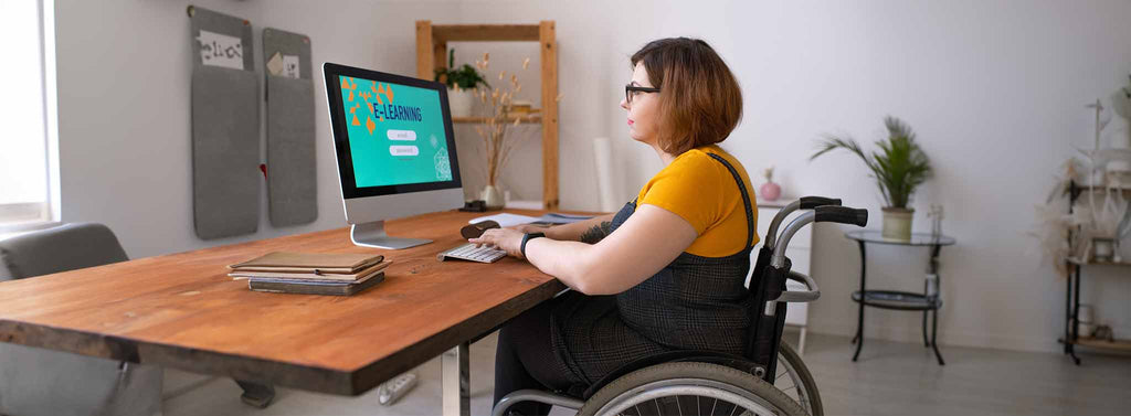 Women in wheel chair with easy access to a computer.