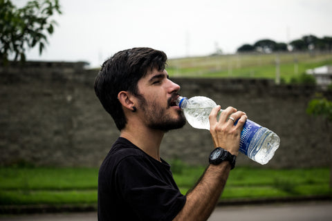 a man with hold a water bottle