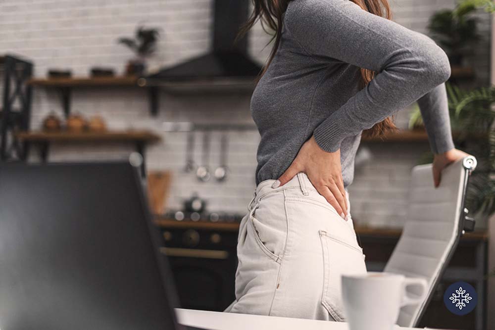 Woman holding her back in pain