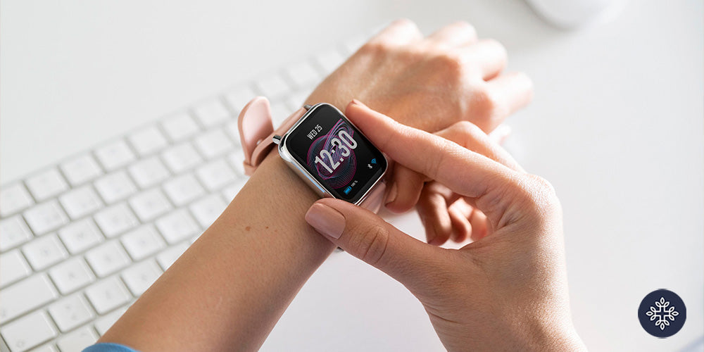 A hand with a digital watch marking 12:30 pm