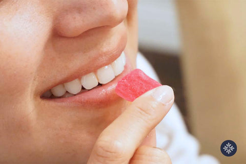 Woman eating a CBD red gummy