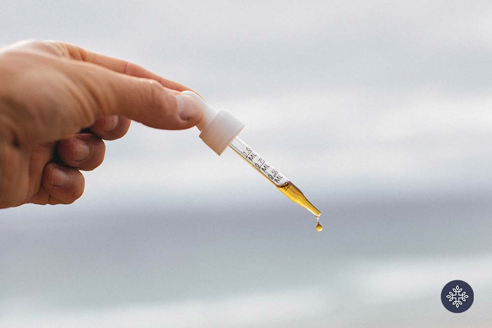 Hand holding a CBD Oil dropper