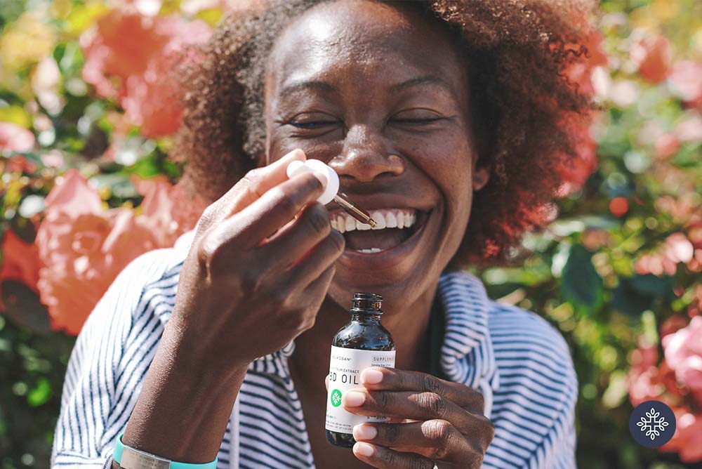 Woman putting a dropper in her mouth