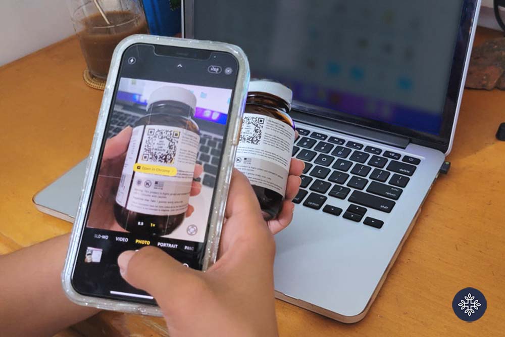 Person scanning a barcode lab report on the back of a CBD label