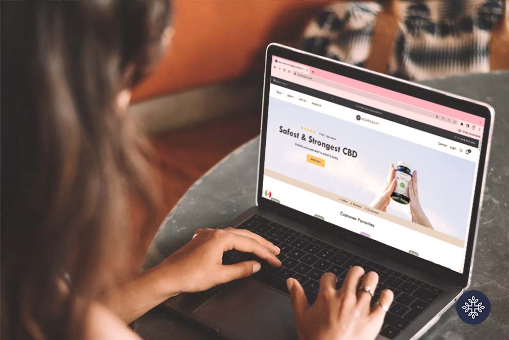 Woman sitting in a table looking around Neurogan's website in her laptop