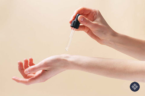 Woman applying oil to her skin