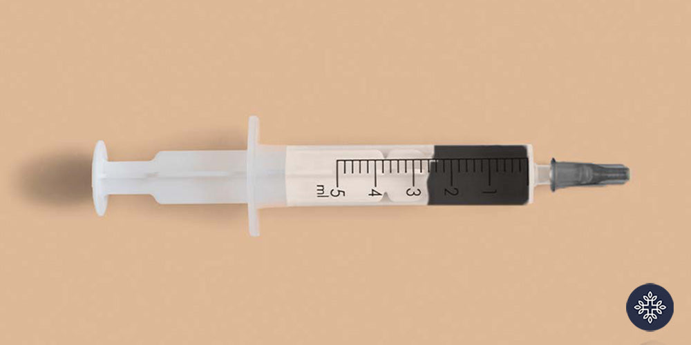 RSO syringe on a flat surface