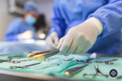 hand close-up to a table of surgery utensils