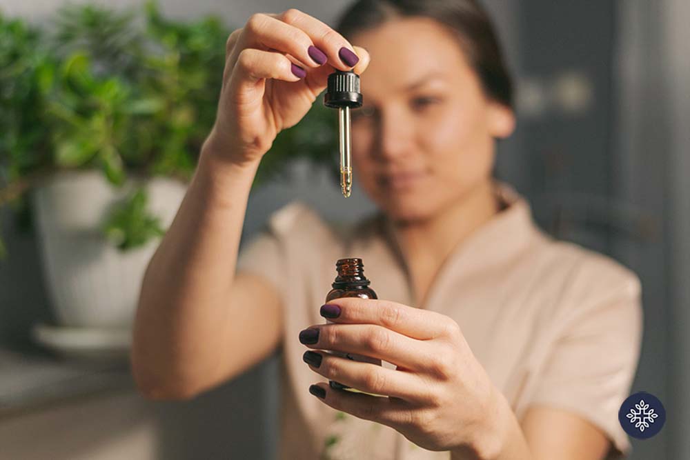 Woman holding a CBD Oil dropper