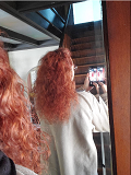ONC NaturalColors 7RN Irish Red Hair Dye With Organic Ingredients 120 mL / 4 fl. oz. LA  product review. Model is standing with her back to the mirror photographing the mirror image of her newly colored hair over her shoulder - Thumbnail