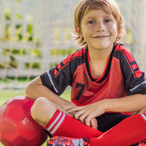 kid in red soccer gear