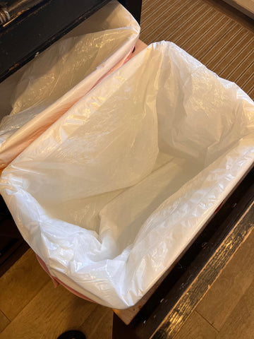 trash bag covering entire trash can