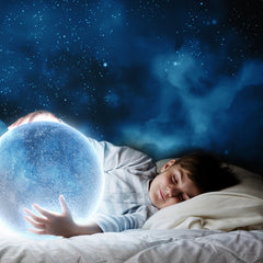 sleeping child holding the world in his hands