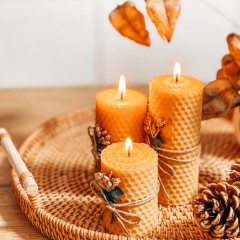 rolled beeswax candles in a rattan basket