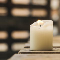 pillar candle on wooden table