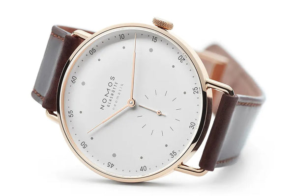 Nomos rose gold watch with brown strap