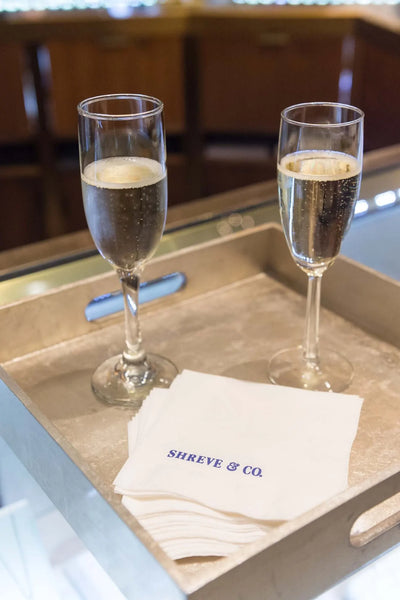 Champagne in glasses with Shreve & Co napkins