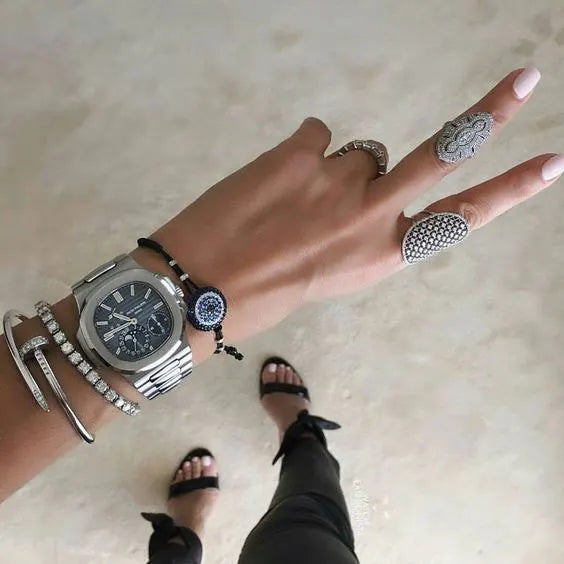 Layered jewlery on hand and arms