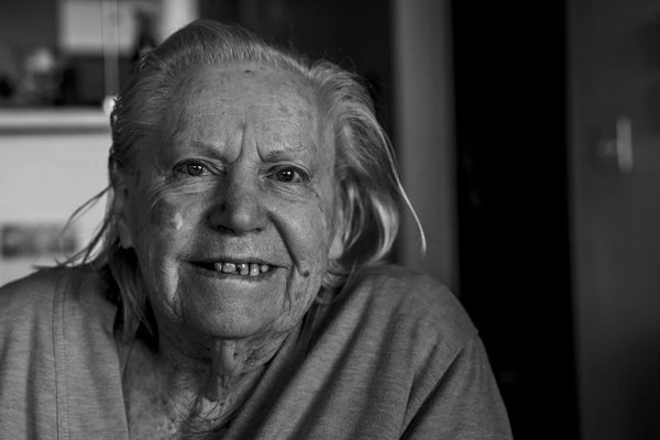 Lady after receiving her meals on wheels food smiling