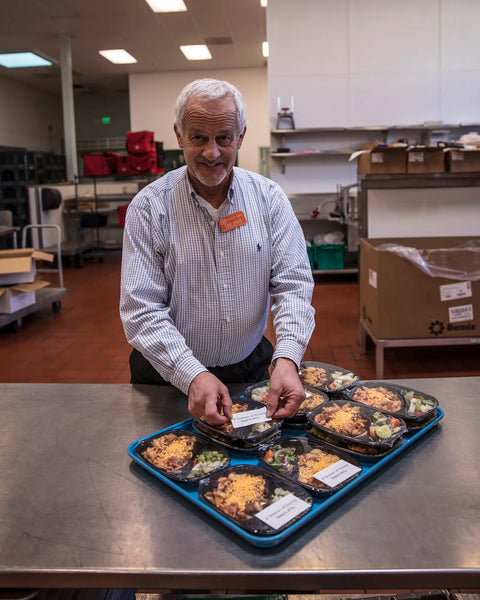 Chef preparing meals on wheels meals