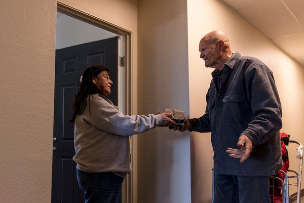 Meals on wheels volunteer delivering food