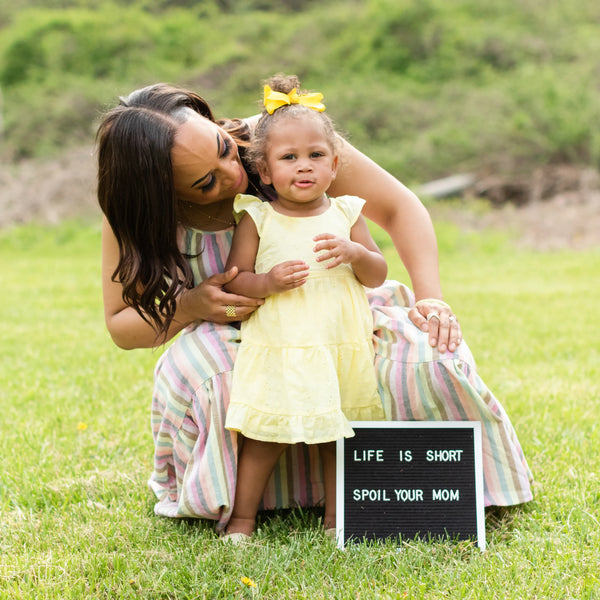 Mother and daughter standing together